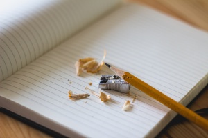 Yellow Pencil with hand Sharpener and Shavings on Notebook